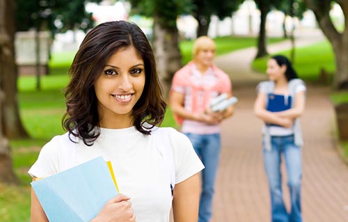 female student walking and smiling