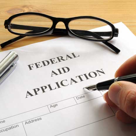 student filling out a federal aid form for college