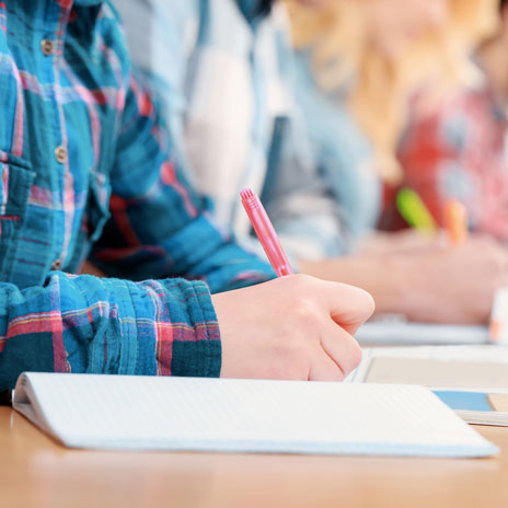 Students writing in notebooks during classroom study session