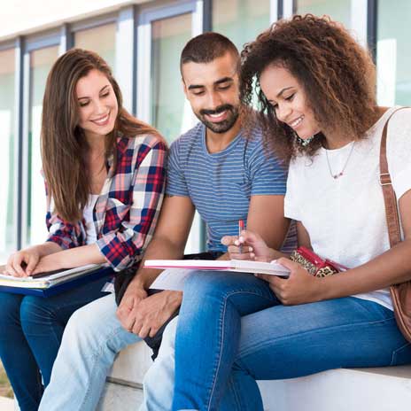 Three students studying together outdoors