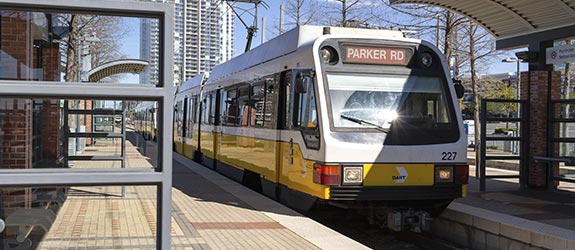 A DART rail train waits at a train station