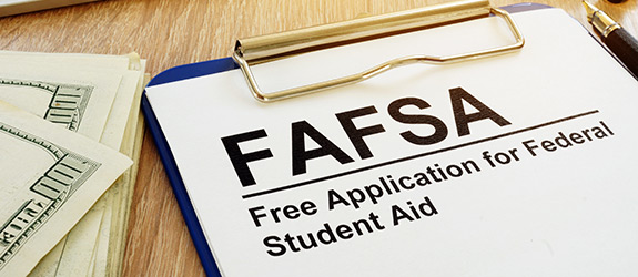 A FAFSA paper form on a clipboard