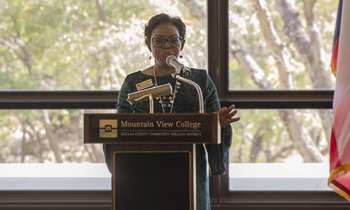 Kenya Ware, speaker at the Bilingual Education Center event, standing at the podium.