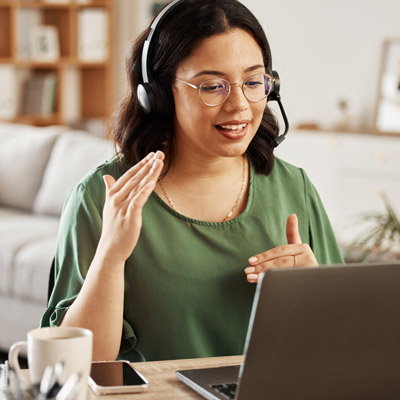 A student wearing a headset receiving tech support through a call