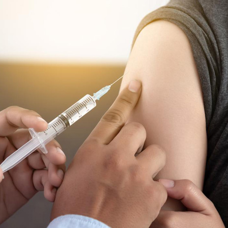 A person gets a vaccine shot in their upper arm