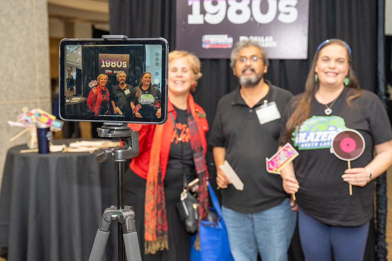 Employees share stories with an iPad at Conference Day