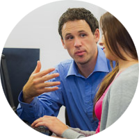 Teacher talking to a student on a computer