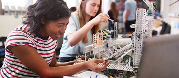Students work in a lab with beakers and test tubes