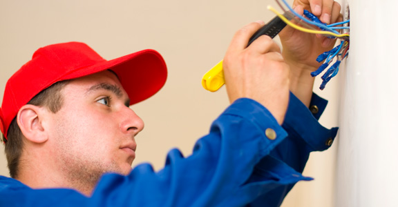 An electrician checks the voltage on a wire