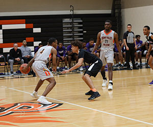 The Cedar Valley Suns dribble the basketball up the court in front of an opposing player
