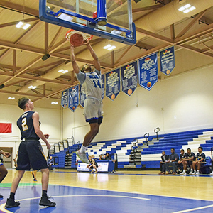 A North Lake basketball player dunks the ball into the net