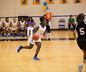 A Mountain View basketball player dribbles the ball up court during a game