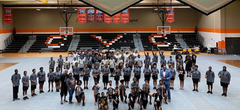 The Cedar Valley band stands in formation inside the gym