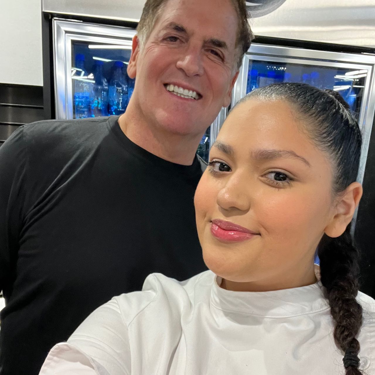A culinary student poses with Mark Cuban at her restaurant