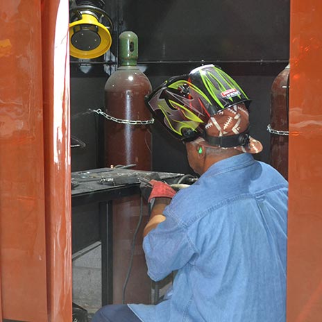 a student welder practices
