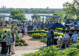 chefs and attendees mingle at the Dallas Arboretum overlooking White Rock Lake during Bits and Bites