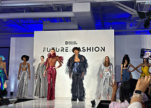 several models stand on a runway; Dallas College Future of Fashion can be seen on the backdrop