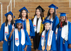 the seven 2025 graduation speakers in their caps and gowns