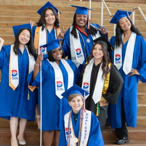 the seven 2025 Dallas College graduation speakers in their caps and gowns