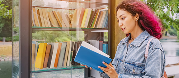 female student looking at library books