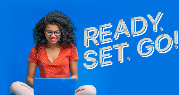Female student sits with a laptop with text beside her that reads Ready. Set. Go!
