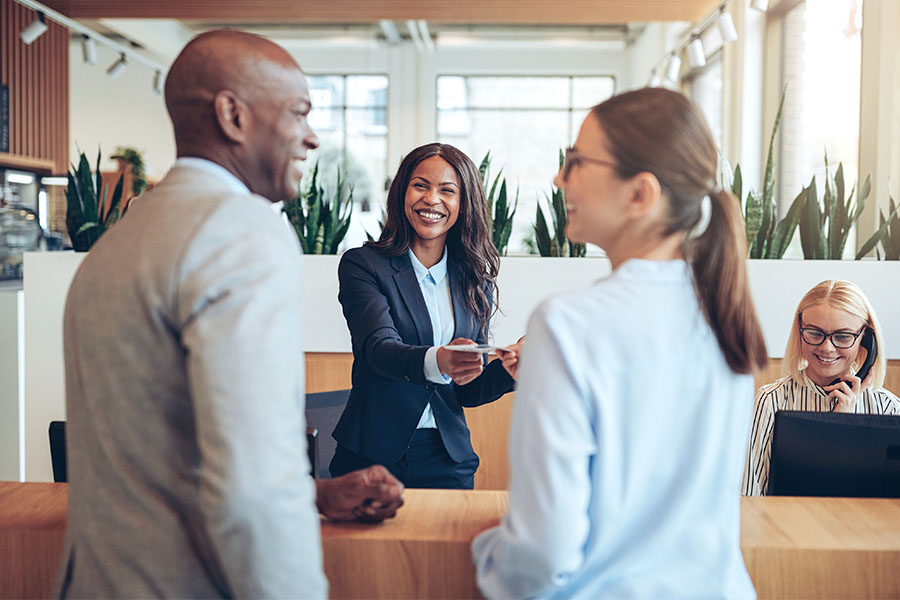 People being helped at hotel check in counter