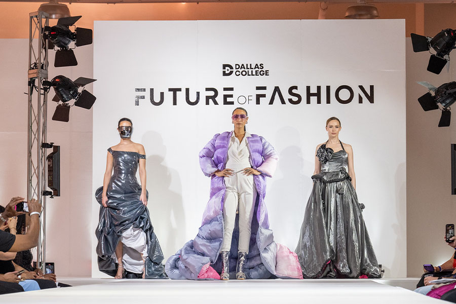 Models pose on a fashion show runway